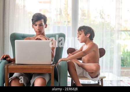 Arabic boy playing on laptop Stock Photo
