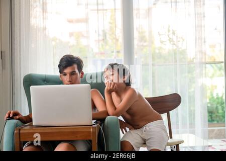 Arabic boy playing on laptop Stock Photo