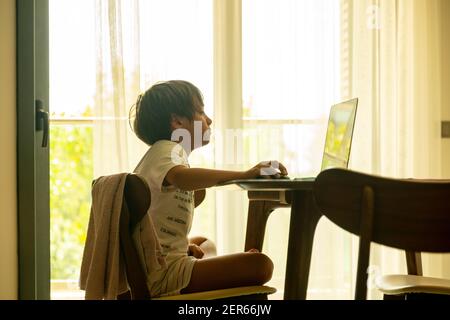 Arabic boy playing on laptop Stock Photo