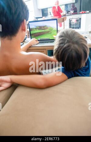 Arabic boy playing on laptop Stock Photo