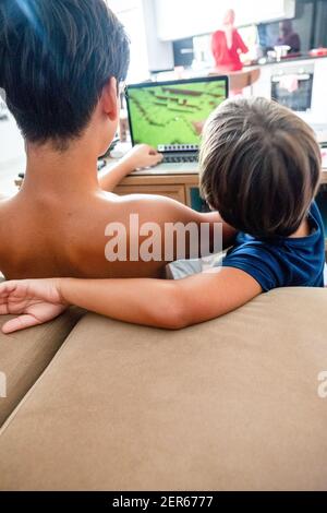 Arabic boy playing on laptop Stock Photo