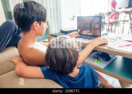 Arabic boy playing on laptop Stock Photo