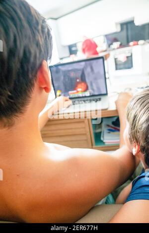 Arabic boy playing on laptop Stock Photo