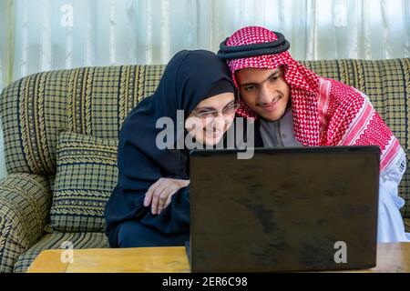 Muslim couple using laptop and discussing business Stock Photo