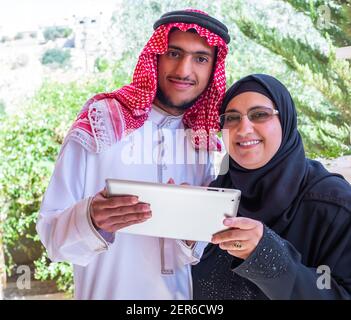 Muslim couple using tablet and discussing business Stock Photo