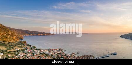 Aerial panoramic view of Komiza village coastline on Vis Island in Croatia sunset hour Stock Photo