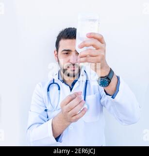 Arabic doctor holding needle in his hand Stock Photo