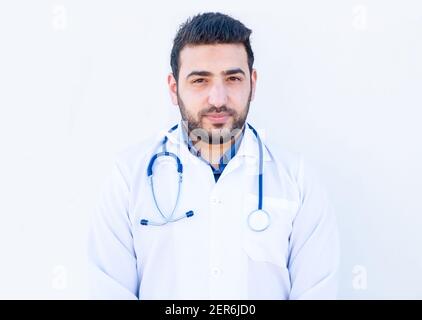 Arabic doctor standing and looking at us Stock Photo