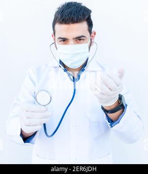 Arabic guy using stethoscope to listen to people heart rate Stock Photo
