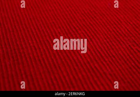Bright red textured fabric. Red textile background. Ribbed fabric. Stock Photo