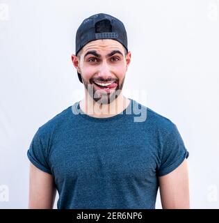 Portrait of happy guy smiling wearing a hat Stock Photo