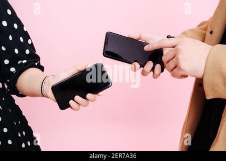 close-up screens phones in the hands of men and women Stock Photo