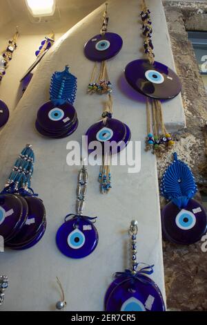 Blue Hamsa TurkishSantorini, Greece - September 11, 2017: Evil Eye beads pendants and trinkets in The main commercial street market of Santorini, famo Stock Photo