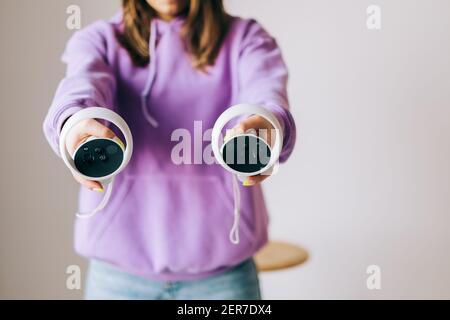 Oculus Quest 2 virtual reality controllers in hands. Stock Photo