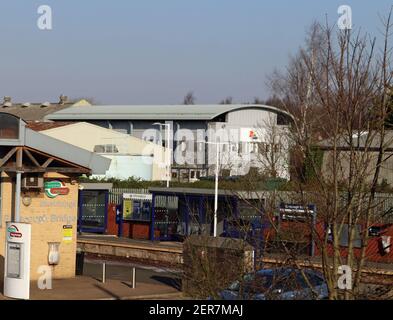 Looking across Burscough Bridge railway station towards the factory and office block of the DS Smith’s packaging factory, the firm is a global concern Stock Photo