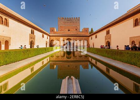 Granada, Spain 07-12-2010: Alhambra Palace complex Reflection pool with the reflection of the palace in the dark waters. Image features the bush fence Stock Photo