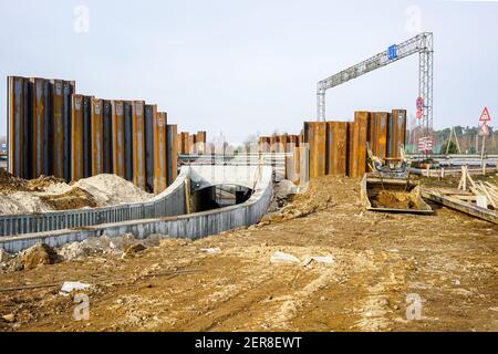 construction of a pedestrian tunnel under the highway, temporary metal retaining wall support the foundation Stock Photo