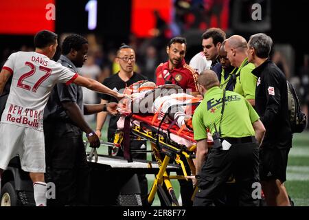 May 20, 2018; Atlanta, GA, USA; New York Red Bulls midfielder Sean Davis (27) reacts to New York Red Bulls defender Kemar Lawrence (92) as he is loaded on to the stretcher and carted off the field after being injured during the second half against the Atlanta United at Mercedes-Benz Stadium. Mandatory Credit: Jasen Vinlove-USA TODAY Sports