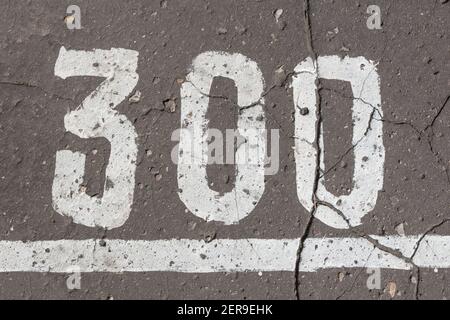Number 300, three hundred, painted on asphalt, running track Stock Photo