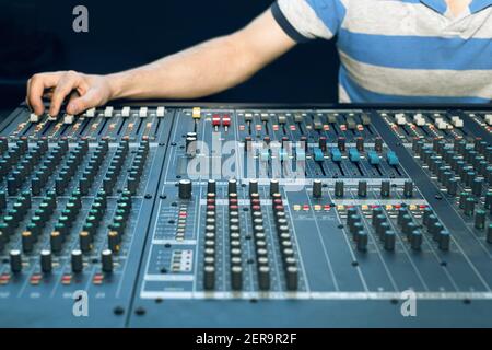 Sound engineer working, professional analog audio mixing console Stock Photo