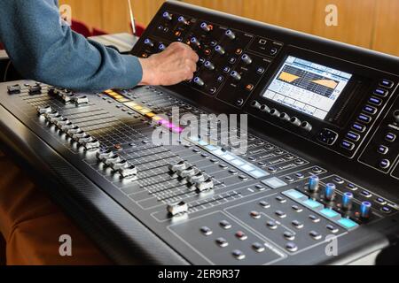 Sound engineer working, professional digital audio mixing console Stock Photo