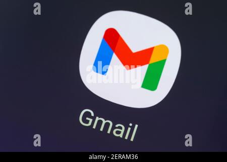A macro closeup of the Gmail app logo on a smartphone / cellphone screen. Gmail is a free email service developed by Google Stock Photo
