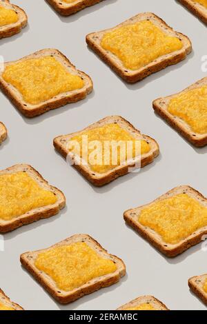 Pattern with toast and lemon jam on gray background Stock Photo