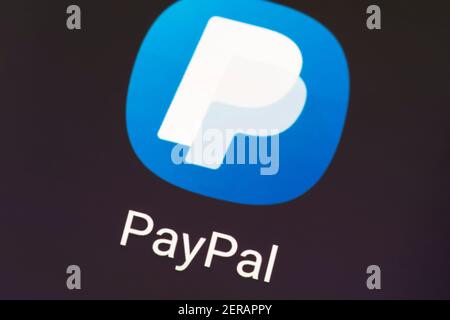 A macro closeup of the PayPal app logo on a phone screen. PayPal Holdings Inc. is an American company operating an online payments system Stock Photo