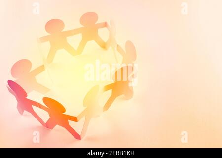 Team of paper chain people holding hands Stock Photo