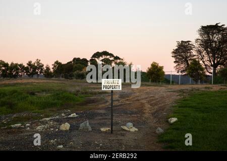 Private property sign post on vacant land. Stock Photo