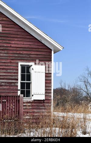 vintage weathered wood historic schoolhouse under blue sky Stock Photo