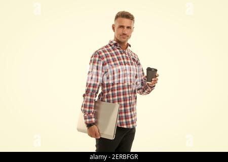 Your online coffee break. Tech worker hold takeaway cup and laptop. Enjoying coffee or tea. Computer specialist relax during work break. Rest break during working day. Pause its break time. Stock Photo