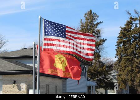 USA flag with US Marine Corps Devil Dogs flag below it in Des Plaines, Illinois Stock Photo