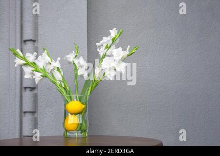 Concept summer flowers setting decoration fresh interior with concrete wall cafe design elements of organic restaurant. Fresh plants in organic cafe Stock Photo