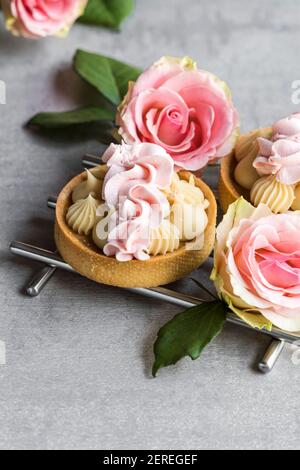 Tarts with caramel and rose cream. Stock Photo