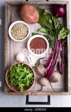 Beets, quinoa, arugula, red onion, sweet potato in wooden box flat lay. Stock Photo