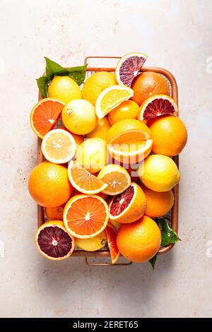 Cut up and whole citrus fruits in a wire basket. Stock Photo