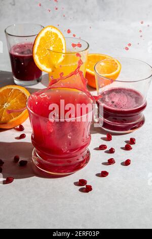 Pomegranate and orange juice splash motion Stock Photo