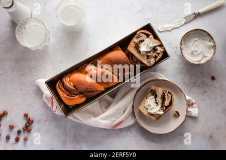 Chocolate and hazelnut babka served with cream cheese. Stock Photo