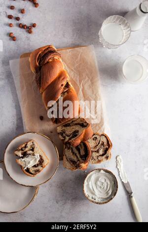 Chocolate and hazelnut babka served with cream cheese. Stock Photo