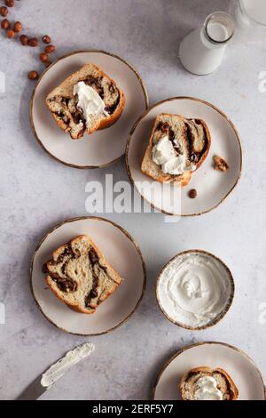 Chocolate and hazelnut babka served with cream cheese. Stock Photo