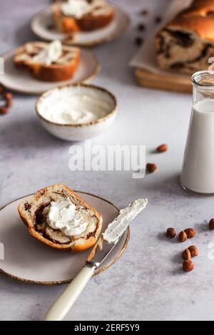 Chocolate and hazelnut babka served with cream cheese. Stock Photo