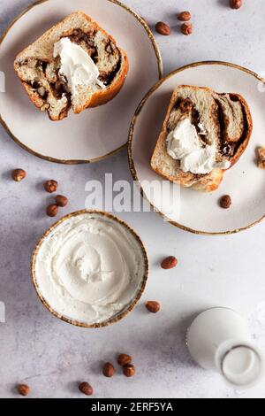Chocolate and hazelnut babka served with cream cheese. Stock Photo
