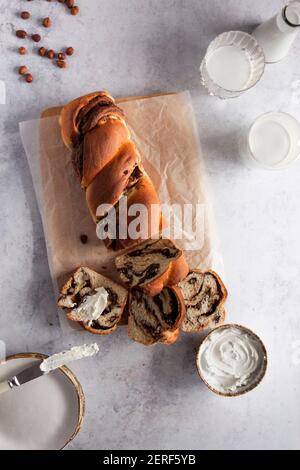 Chocolate and hazelnut babka served with cream cheese. Stock Photo