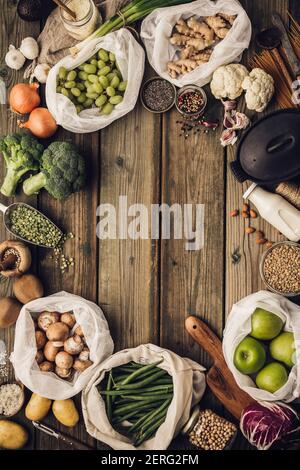 Frame of fruits and vegetables in reusable eco bags at white wooden ...