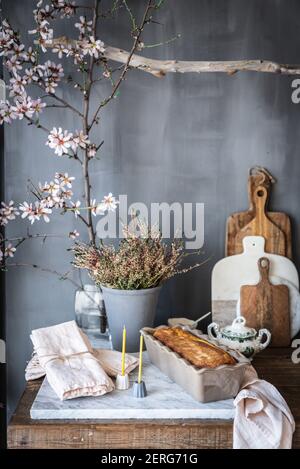 A cake in a tin on a marble counter in a rustic kitchen Stock Photo