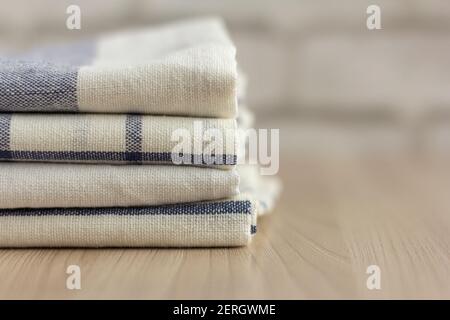 A stack of folded kitchen towels lies on the surface. Stock Photo