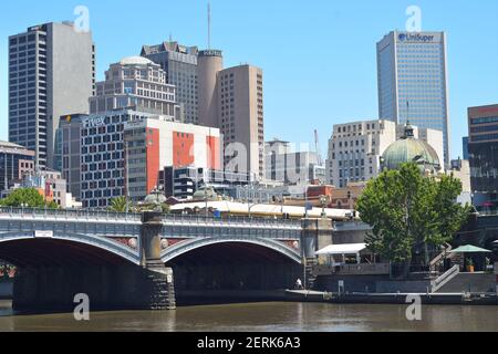 One of numerous bridges over river Yarra surrounded by high rising buildings in Melbourne city centre.