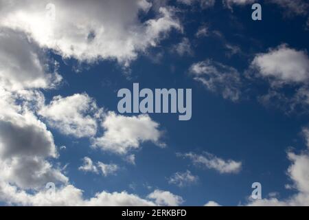Cloudy day, white clouds in the blue sky, scattered clouds. Stock Photo