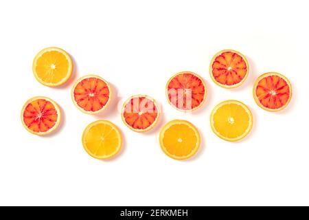 Blood oranges and regular oranges, top shot on a white background with a place for text. The concept of freshness Stock Photo